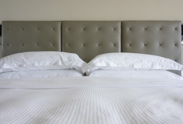 white-bed-sheet-pillow-with-classic-style-grey-colour-bed-head-wall-background_148515-20.jpg
